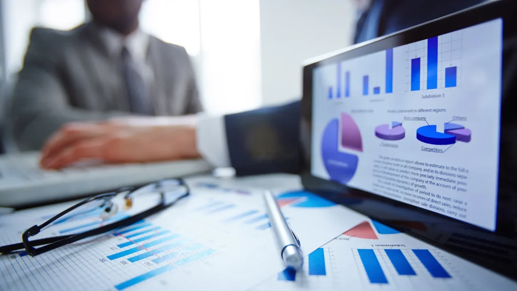 A laptop screen displaying marketing analytics with pie charts and graphs, representing data-driven decision-making in digital marketing director jobs.