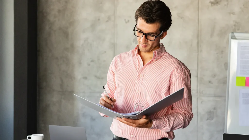 A professional marketing director in a casual office setting reviewing reports, showcasing leadership in digital marketing director jobs.