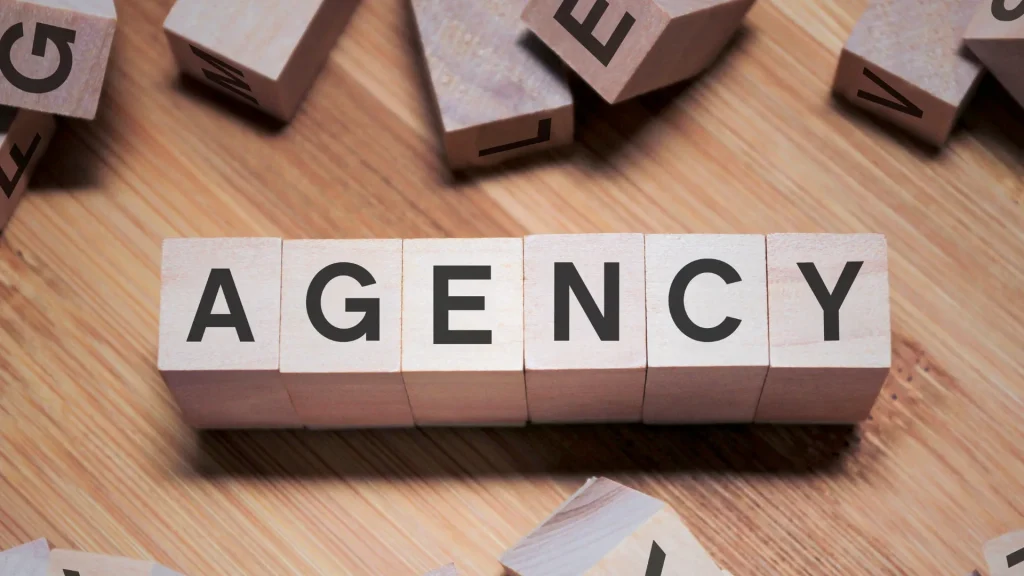  Wooden letter blocks spelling "AGENCY," representing digital marketing recruitment agencies.