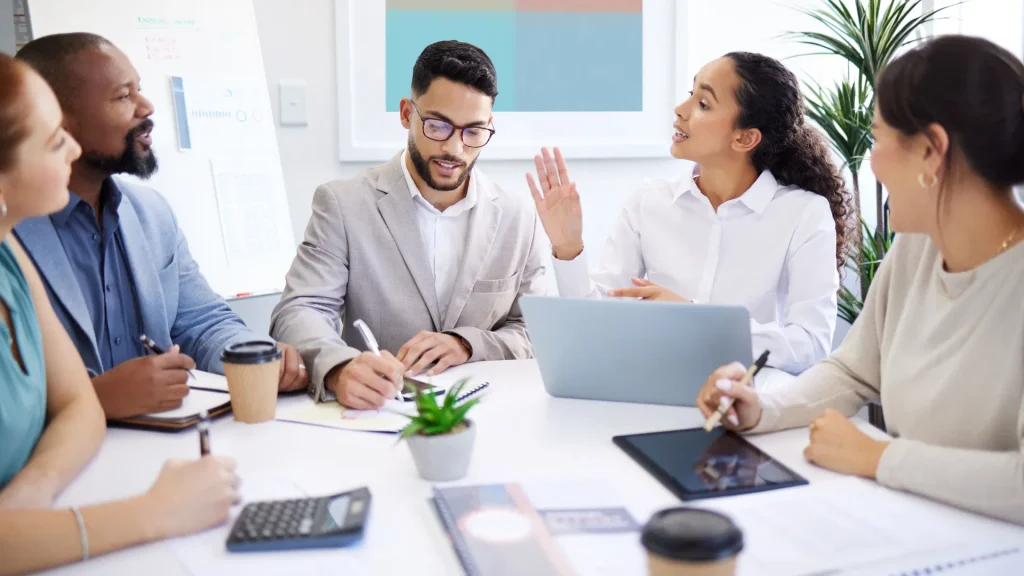 A team of professionals discussing hiring strategies for digital marketing recruitment agencies.