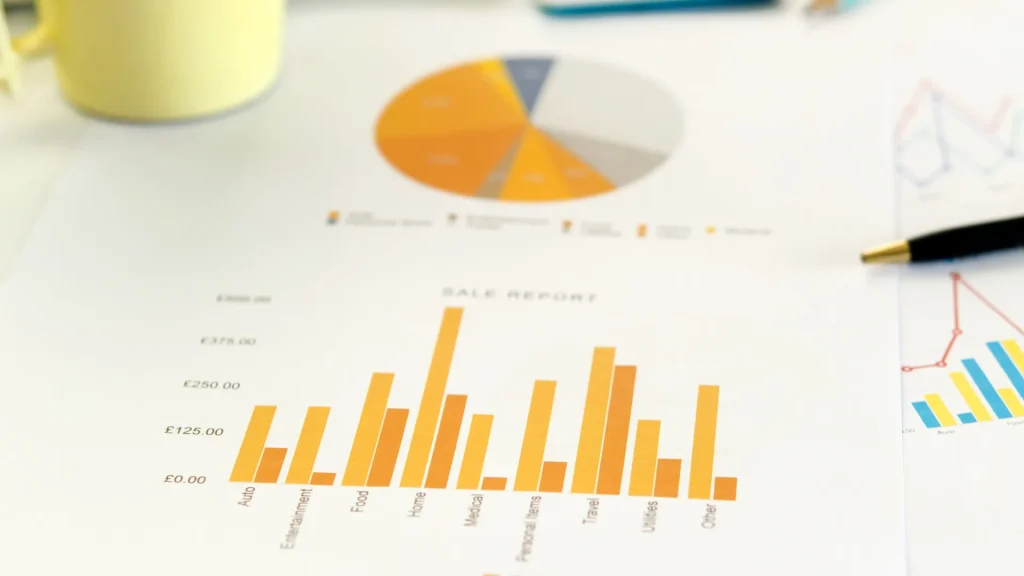 A printed digital marketing report displaying bar and pie charts with sales data insights.
